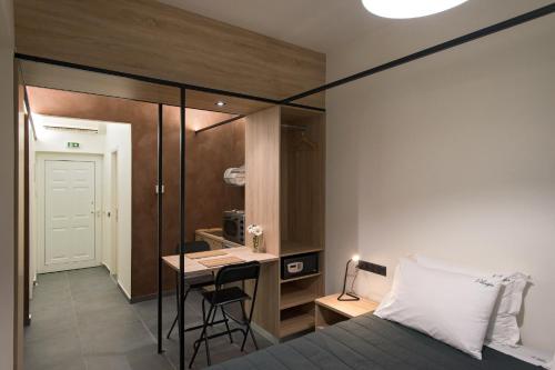 a bedroom with a bed and a table and a desk at Pelagia Sea Side in Acharavi