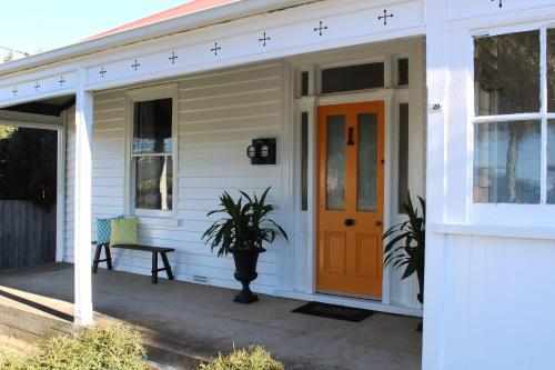 
a white door leading to a patio area with a porch at Signature on Gunn in Devonport

