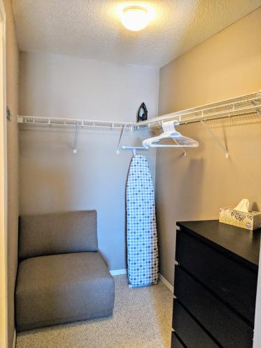 a bedroom with a chair and a closet at Quiet 2 Bed 2 Bath close to Westview Hospital in Stony Plain