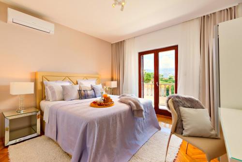 a bedroom with a bed with a table and a window at Villa Sea Breeze in Split
