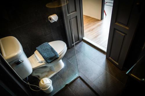 a bathroom with a toilet with a blue blanket on it at Jam Hostel Bangkok in Bangkok