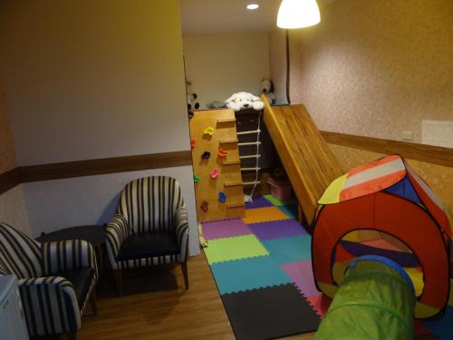 a childs room with a play room with a play house at Sky lounge B&B in Zhushan