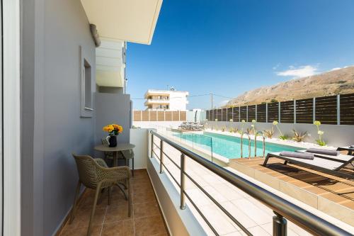 a balcony with a view of a swimming pool at Ethereal Apartments Chania in Souda