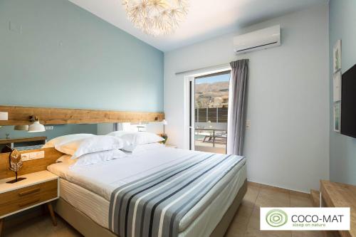 a bedroom with a large bed and a window at Ethereal Apartments Chania in Souda