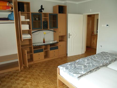 a bedroom with a bed and a book shelf at Apartment Milena in Maribor