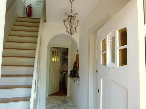 a hallway with a staircase with a chandelier at Ons Buiten in Bergen