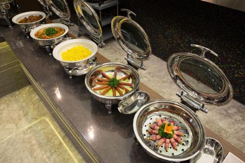 a bunch of bowls of food on a counter at Hotel Mate Bundang in Seongnam