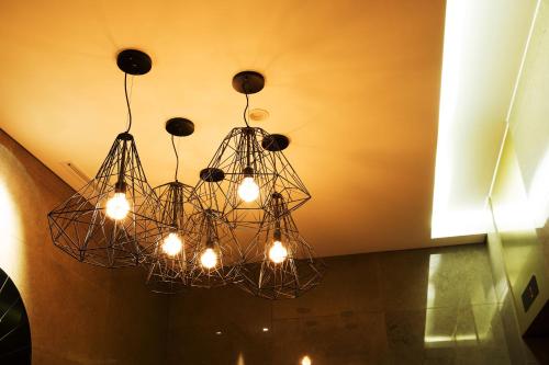 a chandelier hanging from a ceiling in a room at Hotel Mate Bundang in Seongnam