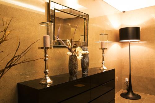 a bathroom with a dresser with two lamps and a mirror at Hotel Mate Bundang in Seongnam