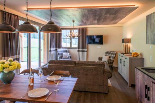 a living room with a couch and a table at Mountain Spa Residences in Sankt Anton am Arlberg