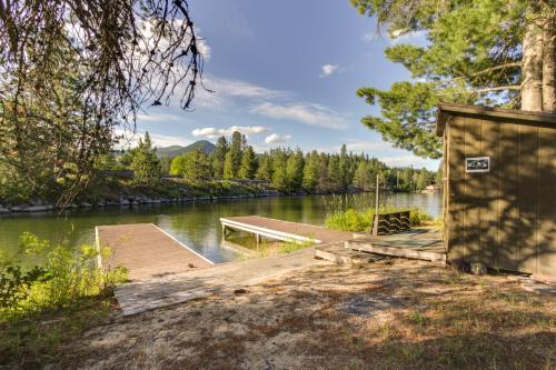 a wooden dock with a boat on a lake at RiverPoint Retreat in Sandpoint
