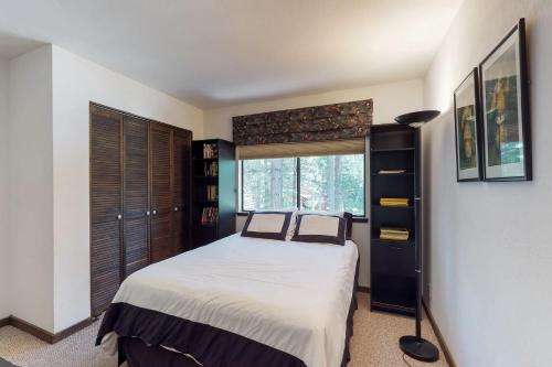 a bedroom with a large bed and a window at Ski View Majesty in Truckee