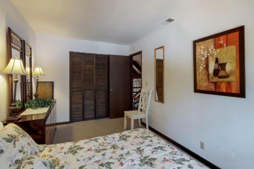 a bedroom with a bed and a table and a chair at Ski View Majesty in Truckee