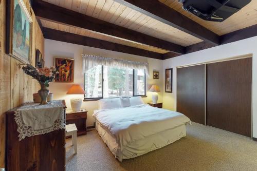 a bedroom with a large bed and a window at Ski View Majesty in Truckee