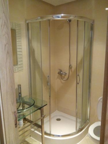 a shower in a bathroom with a sink and a toilet at location de vacance assilah marina golf in Asilah