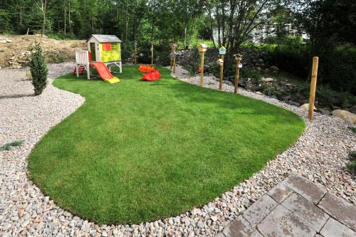 a small yard with a playground and a play area at APLEND Vila Olívia in Smokovce