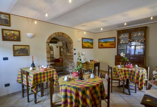 a restaurant with two tables with yellow and red table cloth at B&B La Dolce Vita in Priocca