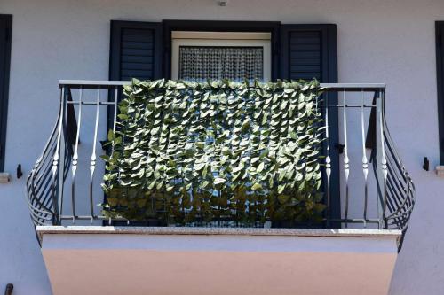 a balcony with a plant on a door at B&B La Dolce Vita in Priocca