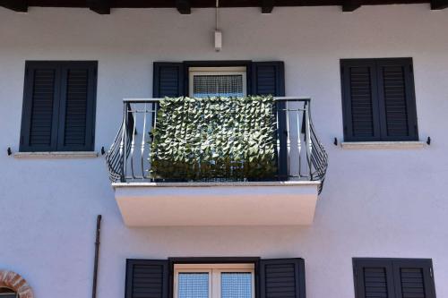 a balcony with a plant on a building at B&B La Dolce Vita in Priocca