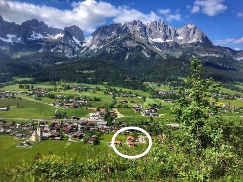 a town in a field with mountains in the background at Chalet Der Tyroler Adler im Zentrum vom Wilden Kaiser in Going