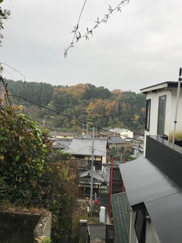a view of a city from the roof of a house at Guest House Hennka Kyoto in Kyoto