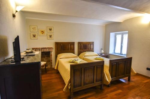 a bedroom with a bed and a television in it at B&B La Dolce Vita in Priocca