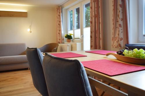 a dining room with a table with a bowl of fruit on it at Haus Partale in Oberstdorf