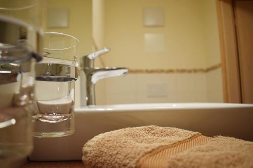 a glass of water sitting on top of a bathroom sink at Haus Partale in Oberstdorf
