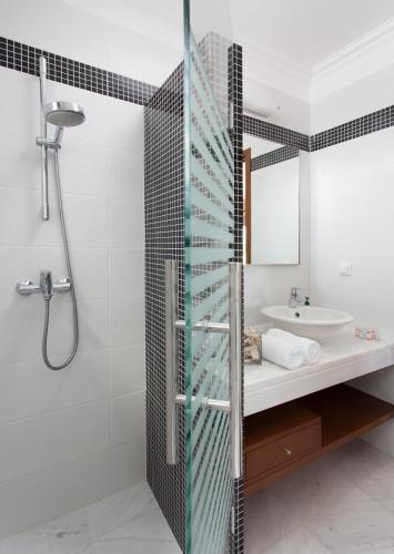 a bathroom with a shower and a sink at Villa Soumela in Nikiana