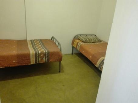 two beds sitting in a room withthritisthritis at Johannesburg Boarding Hostel in Johannesburg