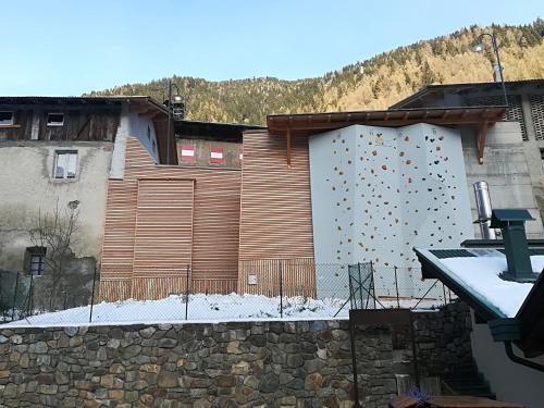 a building with a retaining wall with a fence at B&B Butterfly in Bresimo