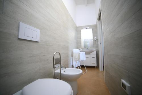 a bathroom with a white toilet and a sink at L'Ulivo e la Stella in Porto Cesareo