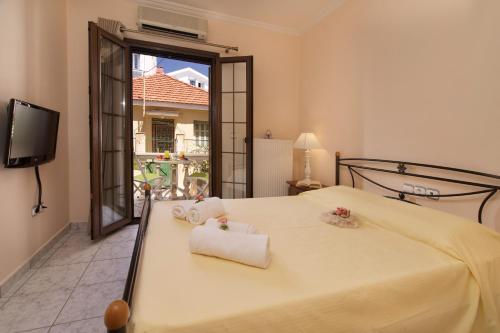 a bedroom with a bed with towels on it at Dias Ground Floor Apartment in Argostoli