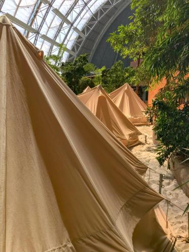 a group of tents in a building with a ceiling at Tropical Islands in Krausnick