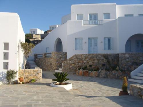 a building with a stone walkway in front of a building at Solaris in Chora Folegandros