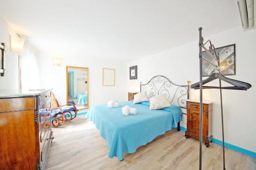a bedroom with a blue bed and a dresser at DolceVita Apartments N 426 in Venice