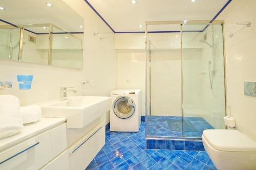 uma casa de banho com uma máquina de lavar roupa no chuveiro em DolceVita Apartments N 426 em Veneza