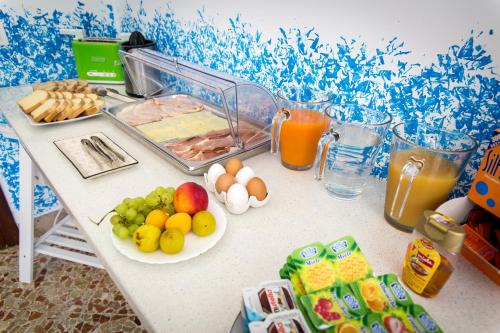 a table with fruits and vegetables and drinks on it at Colors B&B in Palermo