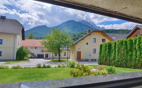 a view from a window of a village with mountains at Apartments and Rooms Banić in Kranjska Gora