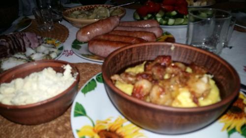 a table topped with bowls of food and other foods at Karpatska Mria in Yaremche