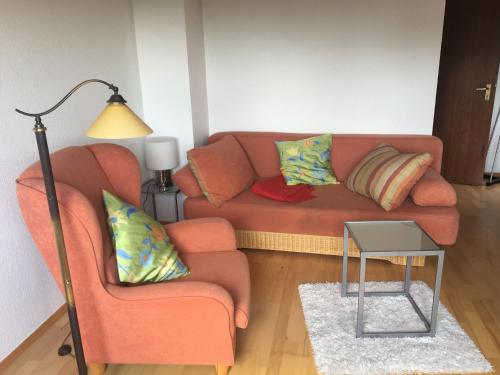 a living room with a couch and a lamp at Fair & the City in Düsseldorf