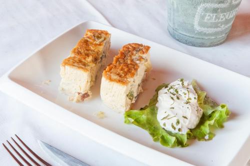 a white plate with two pieces of food on it at Hostal Pagozelai in Gorriti