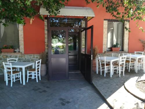 an open door to a restaurant with tables and chairs at Società Agricola F.lli Angelucci in Cannara