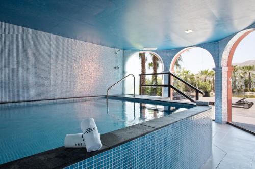 a large swimming pool with a pool at The Level at Meliá Villaitana in Benidorm
