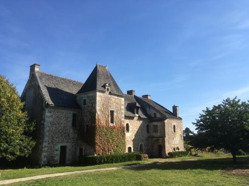 an old stone house on a green lawn at Manoir de Jouralem in Blaison