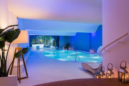 a large swimming pool in a room with blue lighting at Hotel Piccolo Sant'Andrea in Praiano