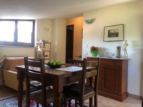 a dining room with a wooden table and chairs at Appartamenti San Rocco in Montefalco