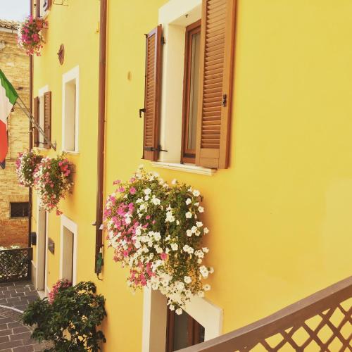 a yellow building with flowers on the side of it at Antico Borgo Chieti in Chieti