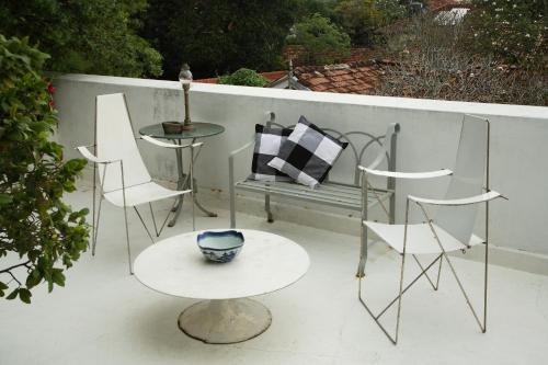 a patio with a bench and a table and chairs at Geoffrey Bawa's Home Number 11 in Colombo