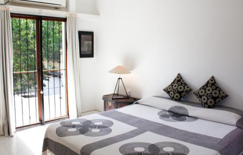 a bedroom with two beds and a large window at Geoffrey Bawa's Home Number 11 in Colombo